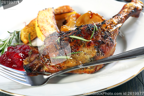 Image of Duck leg with rosemary and cowberry sauce.