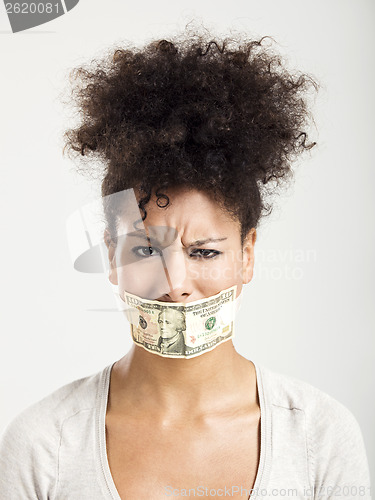 Image of Covering mouth with a dollar banknote