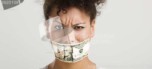Image of Covering mouth with a dollar banknote