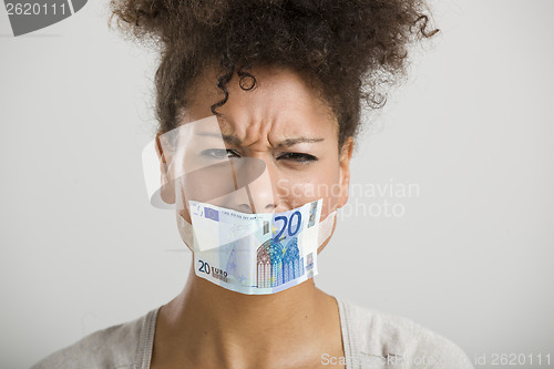 Image of Covering mouth with a euro banknote