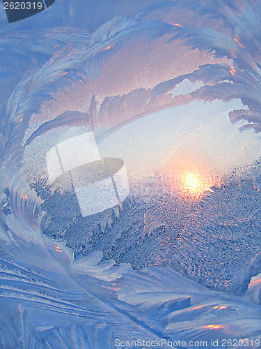 Image of Ice pattern and sunlight on winter glass