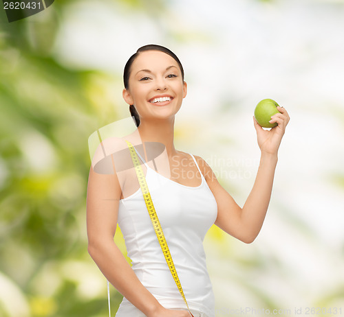Image of sporty woman with apple and measuring tape