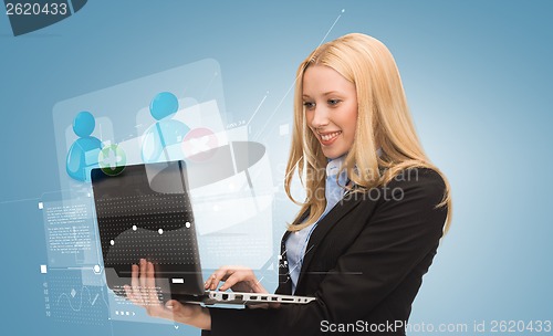 Image of smiling woman with laptop computer