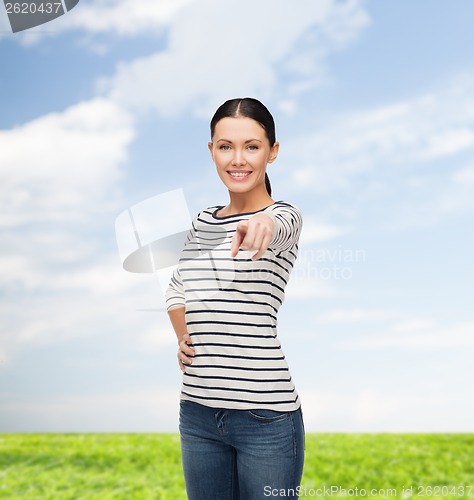 Image of smiling girl in casual clother pointing at you