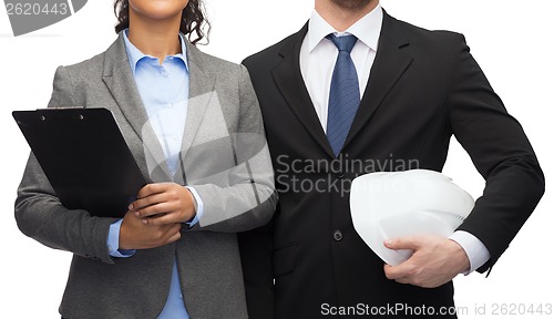 Image of businesspeople with clipboard and helmet