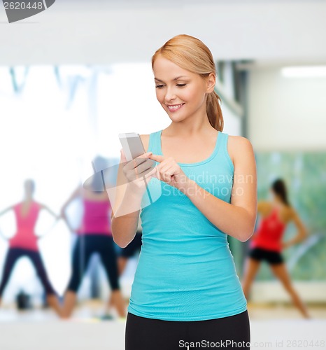 Image of sporty woman with smartphone