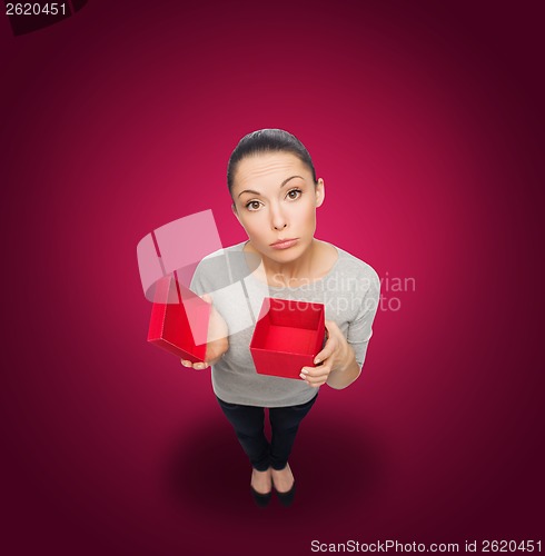 Image of disappointed asian woman with empty red gift box