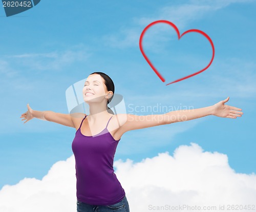 Image of smiling girl in blank purple tank top waving hands