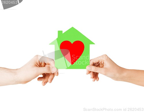 Image of couple hands holding green paper house