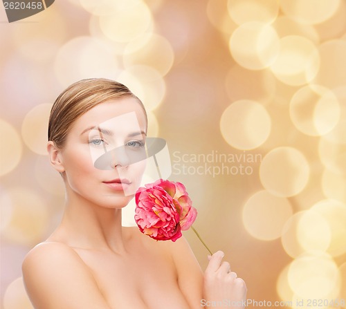 Image of lovely woman with peonie flower