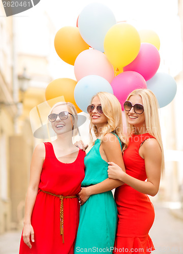 Image of beautiful girls with colorful balloons in the city