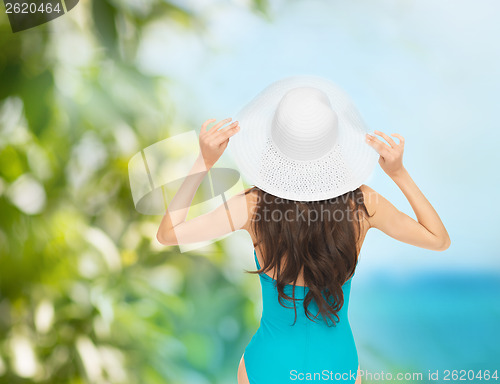 Image of model in swimsuit with hat
