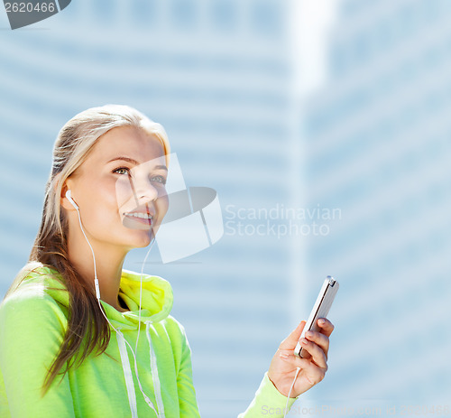 Image of woman listening to music outdoors