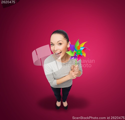 Image of smiling asian woman with windmill