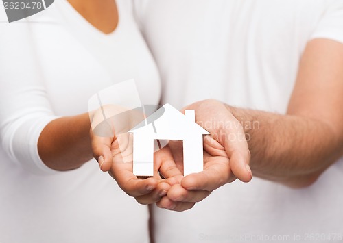 Image of couple hands with paper house