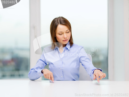 Image of smiling woman pointing to something imaginary