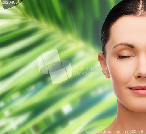 Image of young calm woman with closed eyes