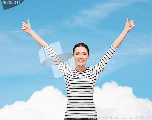 Image of smiling girl in casual clother showing thumbs up