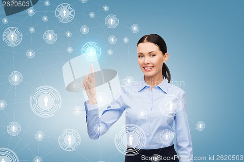 Image of smiling businesswoman pointing finger at you