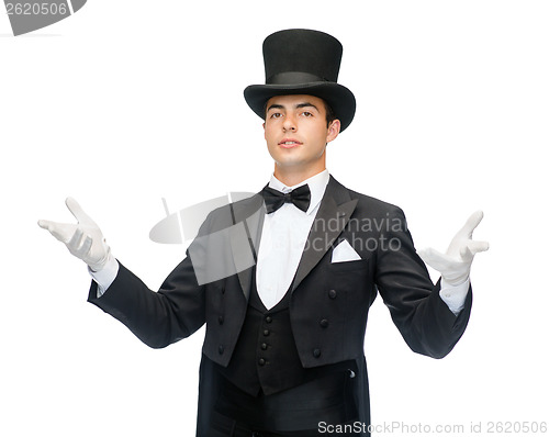 Image of magician in top hat showing trick