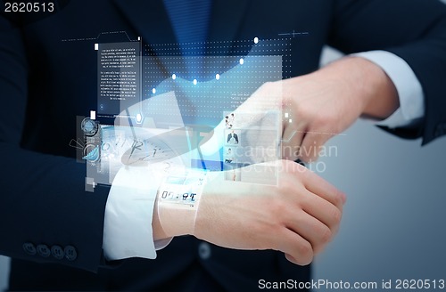 Image of businessman pointing to something at his hand