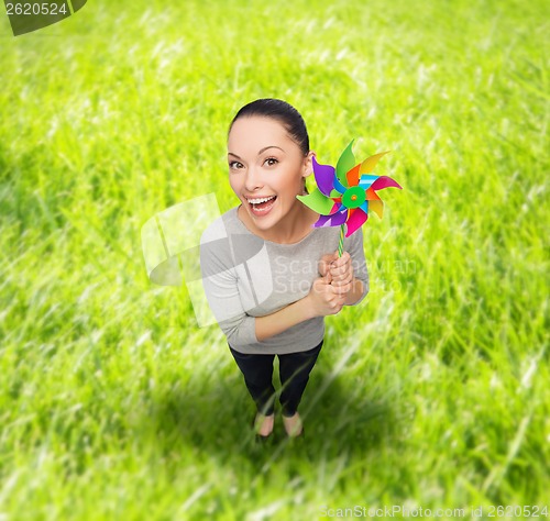 Image of smiling asian woman with windmill