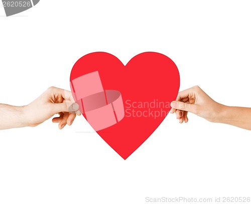 Image of couple hands holding red heart