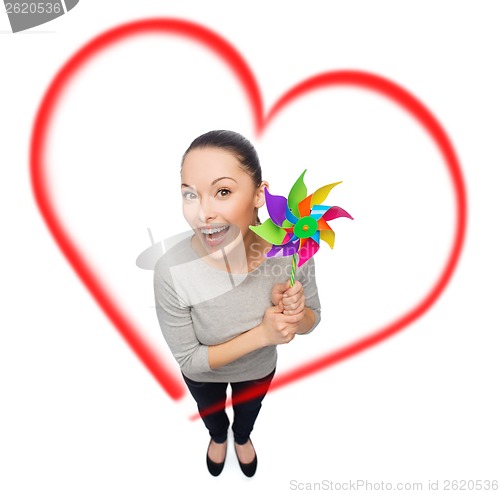 Image of smiling asian woman with windmill