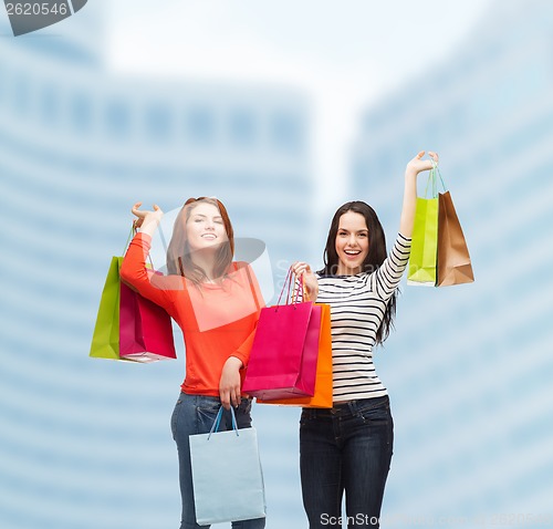 Image of two smiling teenage girls with shopping bags