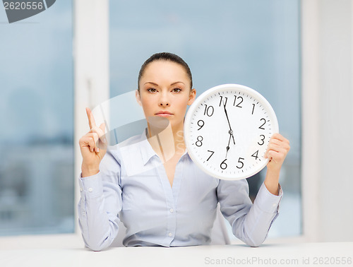 Image of attractive businesswoman with white clock