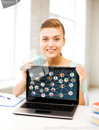 Image of smiling student girl with laptop at school