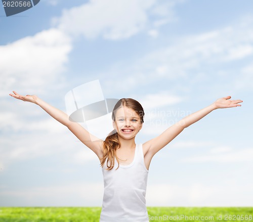 Image of smiling teenage girl with raised hands