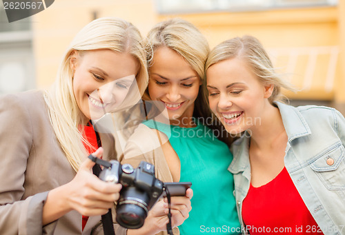 Image of beautiful blonde women with camera in the city