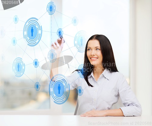 Image of smiling woman writing on virtual screen