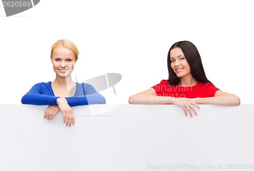 Image of two women with big blank white board
