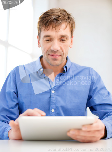 Image of man working with tablet pc at home