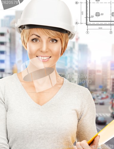 Image of female contractor in helmet with folder