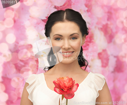 Image of young and beautiful woman with flower