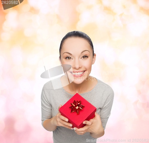 Image of smiling asian woman with red gift box