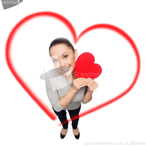 Image of smiling asian woman with red heart