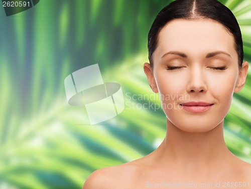 Image of young calm woman with closed eyes