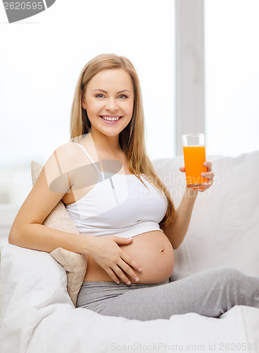 Image of happy pregnant woman with fresh orange juice