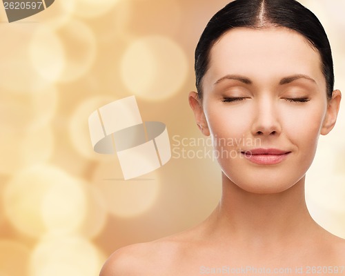 Image of young calm woman with closed eyes