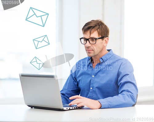 Image of man working with laptop at home