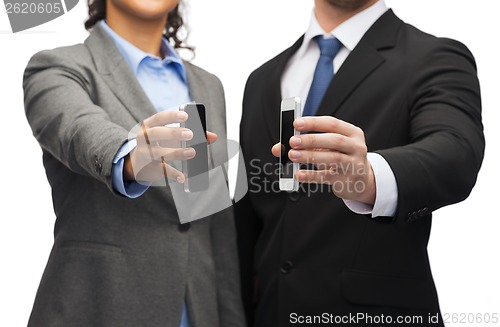 Image of businessman and businesswoman with smartphones