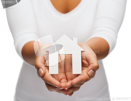 Image of woman hands with paper house