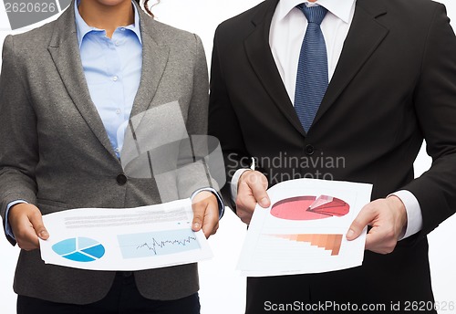 Image of businesspeople with graphs and charts