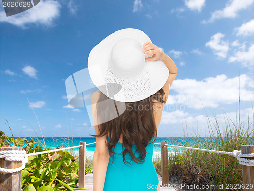 Image of model in swimsuit with hat