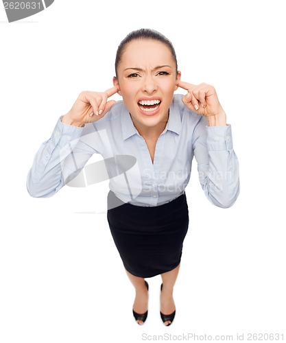 Image of businesswoman screaming with closed ears