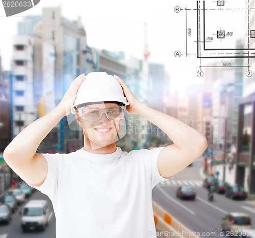 Image of male architect in helmet with safety glasses